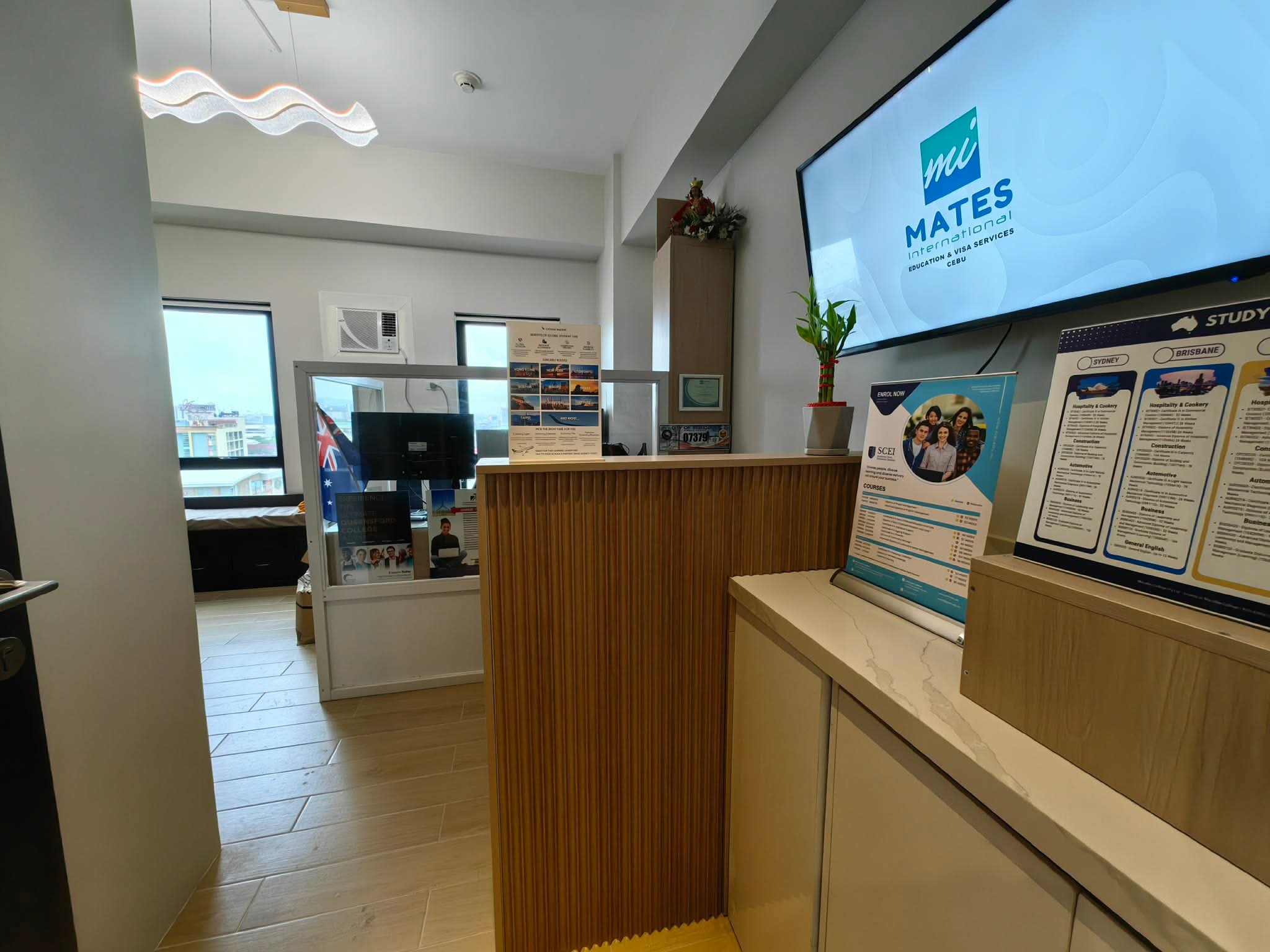 MATES Cebu reception desk with the MATES logo displayed on screen